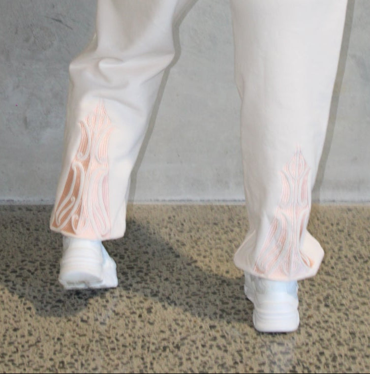 Person wearing a light-colored outfit on a concrete floor